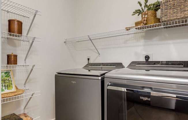 A kitchen with a stainless steel oven and a black dishwasher.