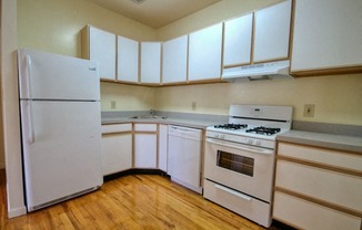 Kitchen with white and wooden cabinets and grey counter tops