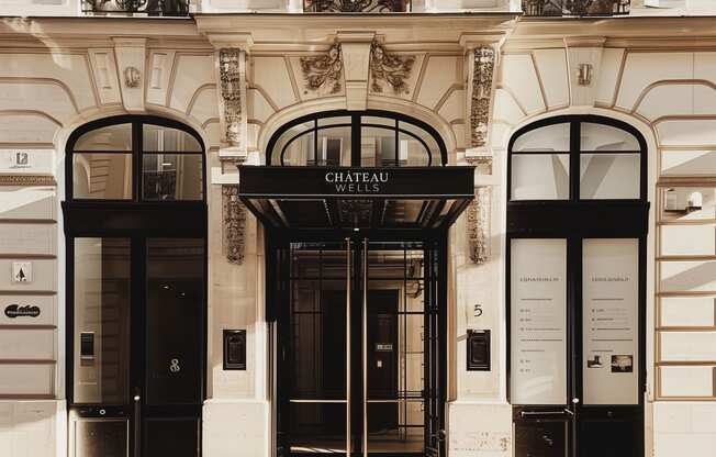 the facade of a building with two black doors