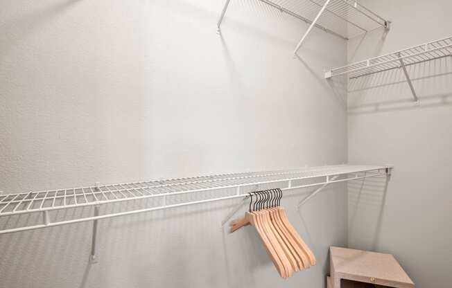 the walk in closet in the master bedroom has a wire shelf and a dresser at Mission Gate, Plano, Texas