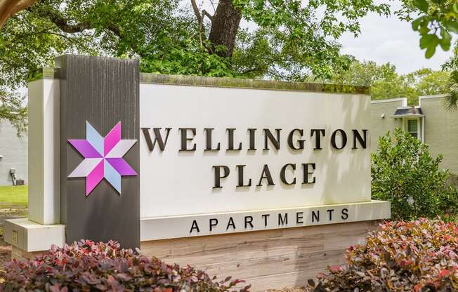 a sign for wellington place apartments