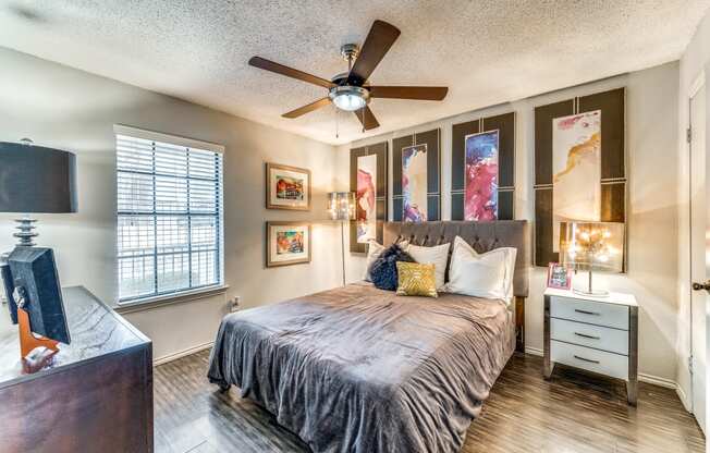 a bedroom with a large bed and a ceiling fan