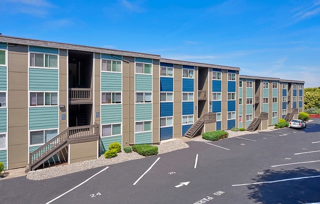 Outside apartments with numbered parking spots and well-maintained landscaping.
