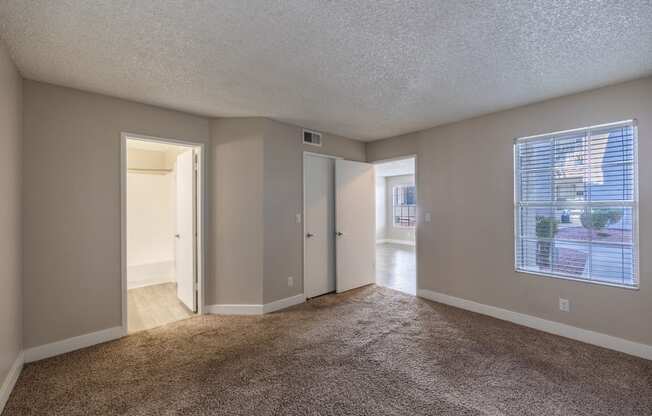 bedroom with a large window and carpeting