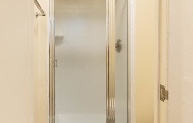 a bathroom with a shower and toilet in a 555 waverly unit  at Charlesgate Apartments, Maryland