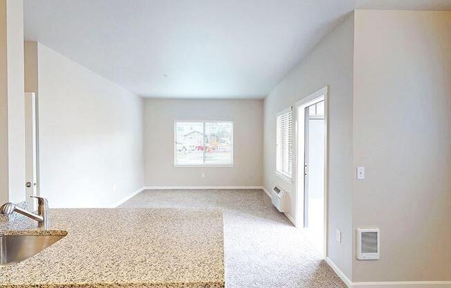 an empty room with a sink and a window