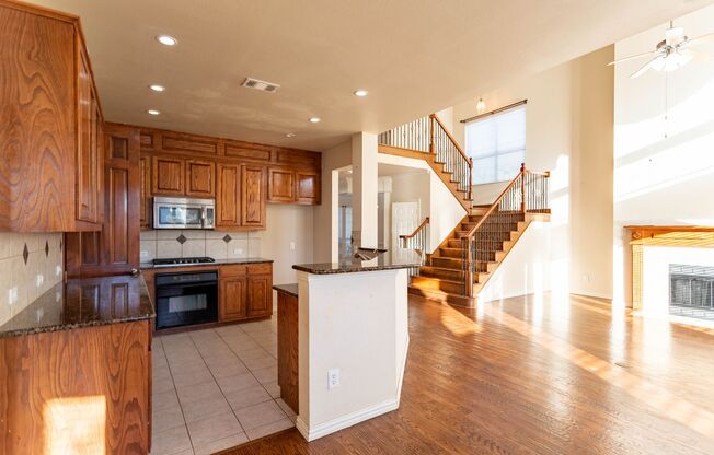 Well kitchen featuring granite countertops, a large island.