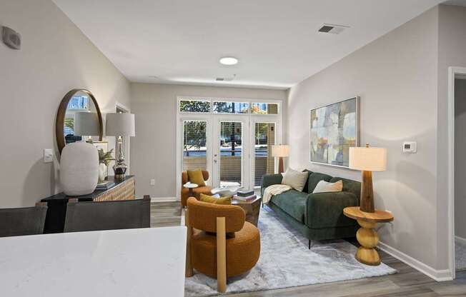 Flatiron West Trade Apartments staged model unit living room with luxury vinyl tile flooring and quartz countertops