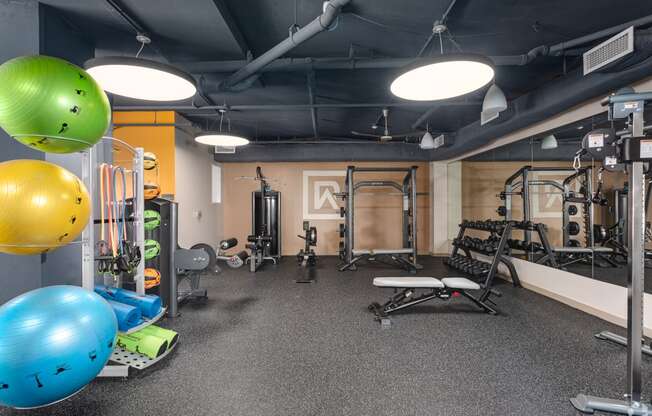 a workout room with weights and other gym equipment