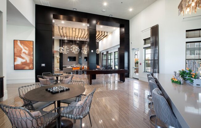 a dining room with a table and chairs and a piano at North Creek, Hutto, TX