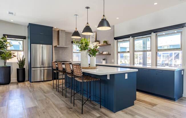 a large kitchen with blue cabinets and a white counter top