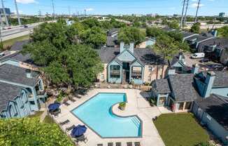 an aerial view of a house with a swimming pool and a courtyard