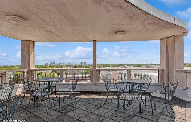 the patio has tables and chairs and a view of the water