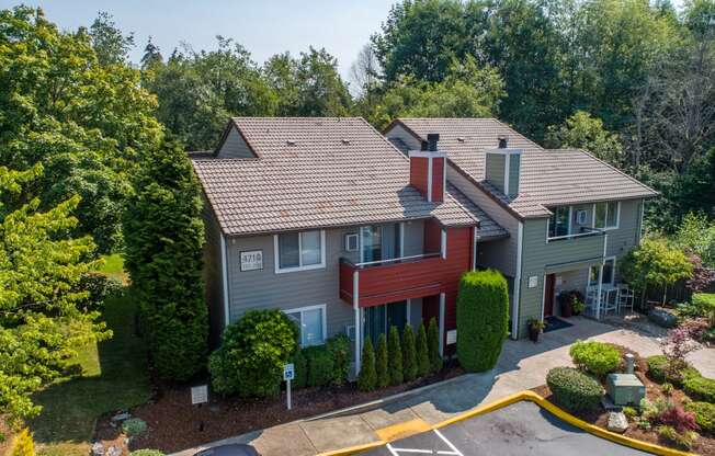 an aerial view of a home with a red and gray house and trees at Quartz Creek, Washington