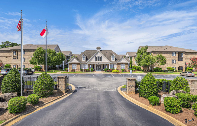 A road leading to a building with flags on either side.