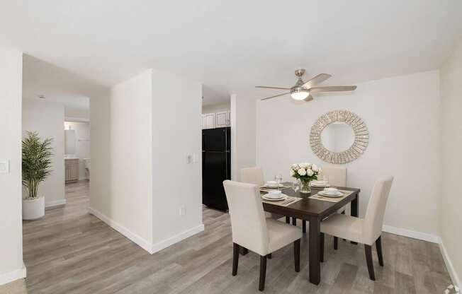 A dining room with a table set for four.