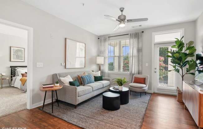 a living room with a couch and a ceiling fan