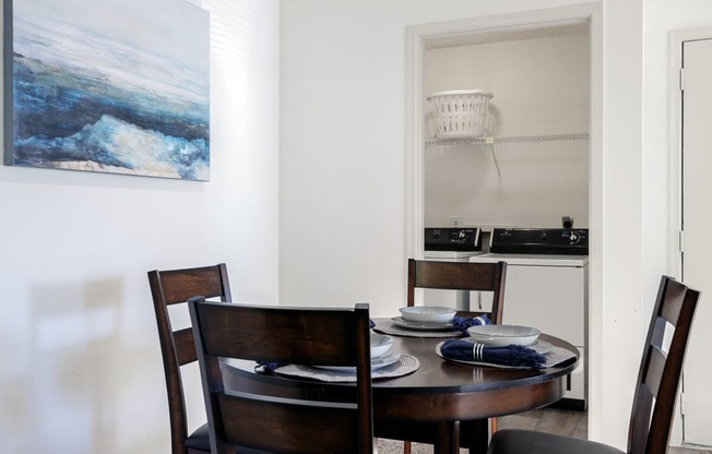 a dining room with a wooden table and chairs