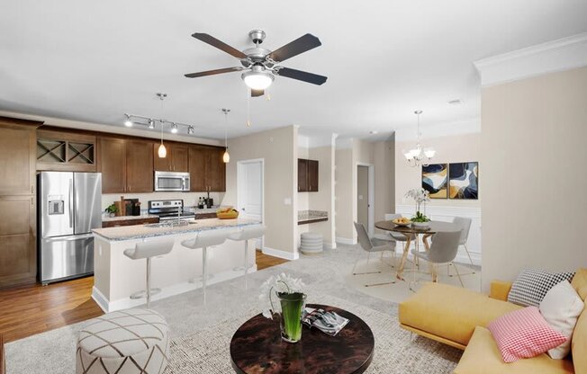a living room and kitchen with a ceiling fan