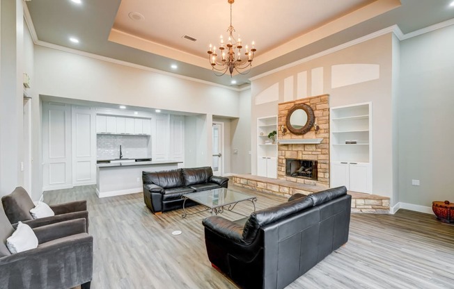 a living room with leather couches and a fireplace