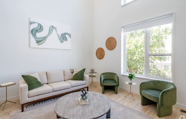 a living room with a couch and chairs and a coffee table