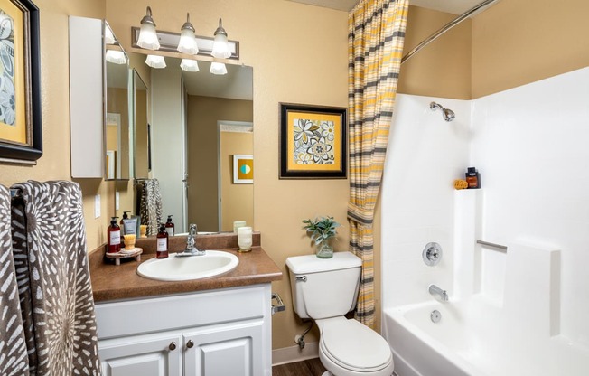 a bathroom with a shower and a toilet and a sink