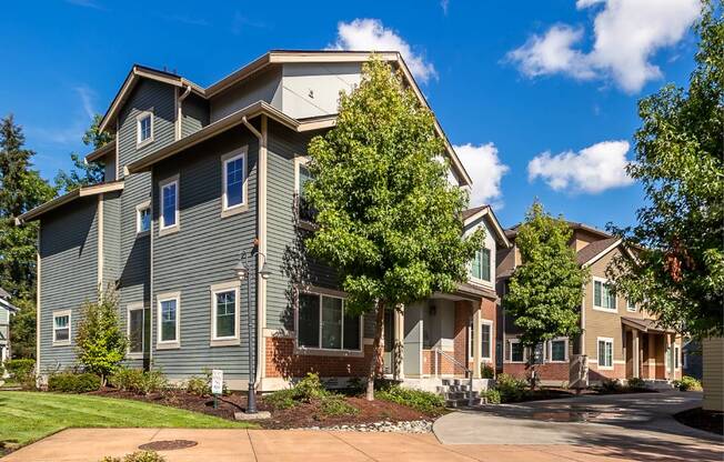 A large house with a driveway in front.