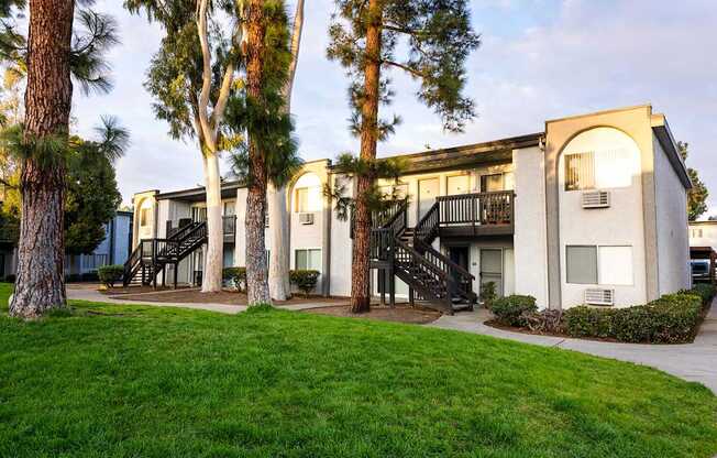 A building with a white facade and a black staircase.
