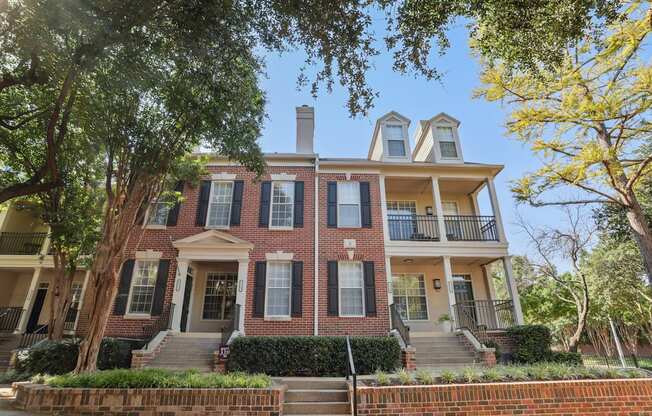 A red brick house with a white door and windows.