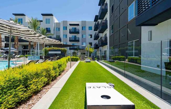 a backyard with a hot tub and grassy area