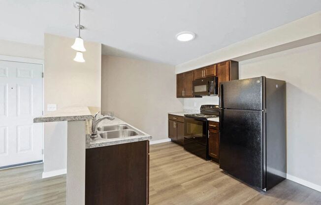 a kitchen with a refrigerator and a sink