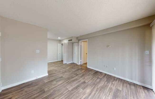 a living room with hardwood floors and grey walls