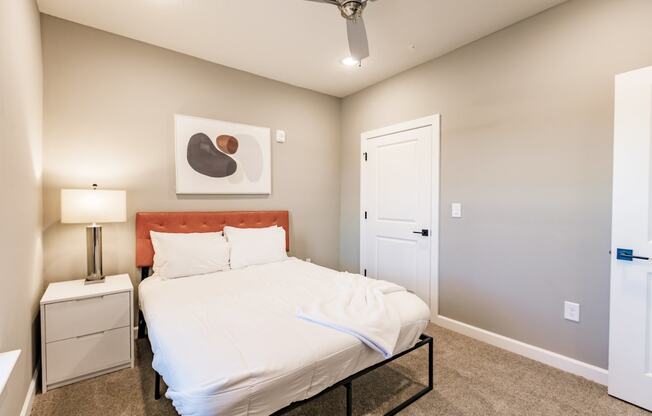 a bedroom with a white bed and a closet