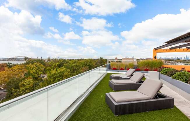a roof deck with couches and a grassy area