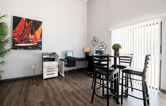 a living room with a dining room table and chairs