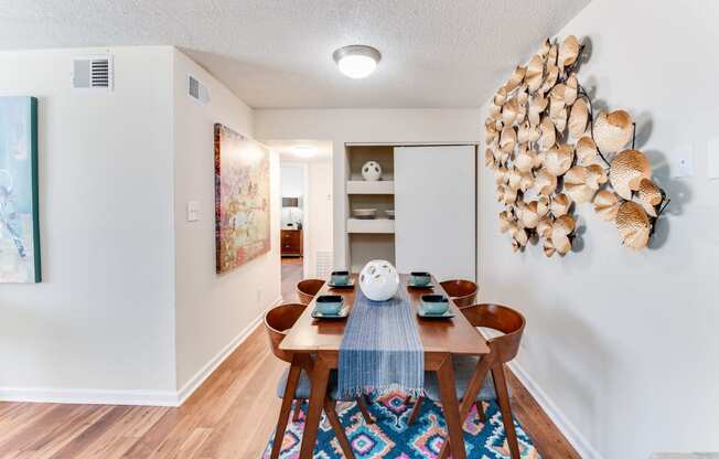 a dining room with a wooden table and chairs