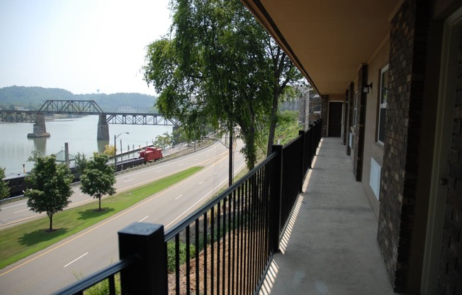 a balcony with a view of a river and a bridge