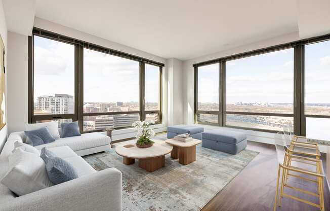 a living room with a large window and a view of the city