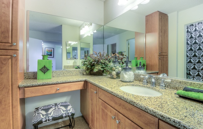 A bathroom with a green bottle on the counter.