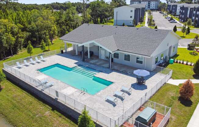 an aerial view of a house with a swimming pool and patio furniture at Gibson Oaks, Lakeland, 33809