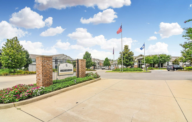 the preserve at ballantyne commons community entrance with a gate and flags