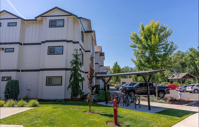 A white apartment building with a green lawn in front at Timberridge Place Apartment Homes, Albany