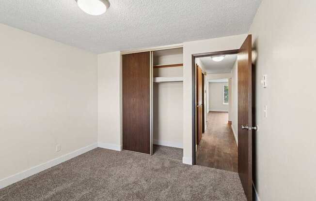 A room with a carpeted floor and a white ceiling with a light fixture.