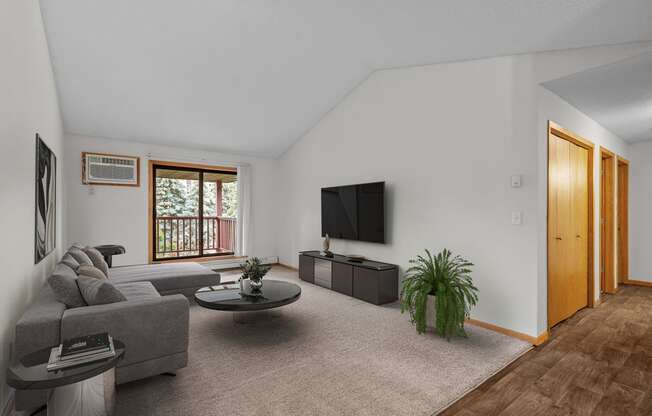 the living room of an apartment with a couch and a tv