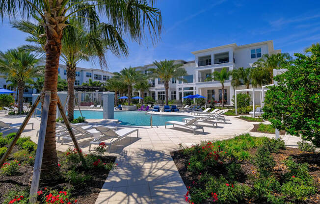 a resort style pool with lounge chairs and palm treesat Altis Grand Lake Willis, Florida, 32821