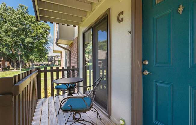 A blue chair is on a wooden deck.