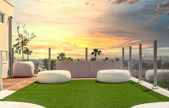a rendering of a rooftop garden with grass and a sunset in the background