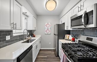 a kitchen with stainless steel appliances and white cabinets