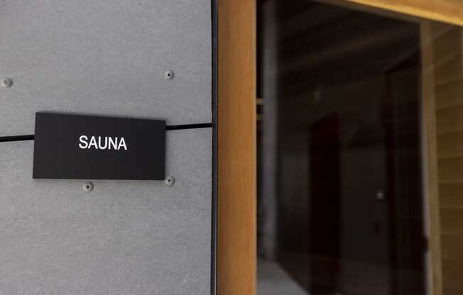 a sign on a building that reads sauna at Analog PDX Apartments, Portland