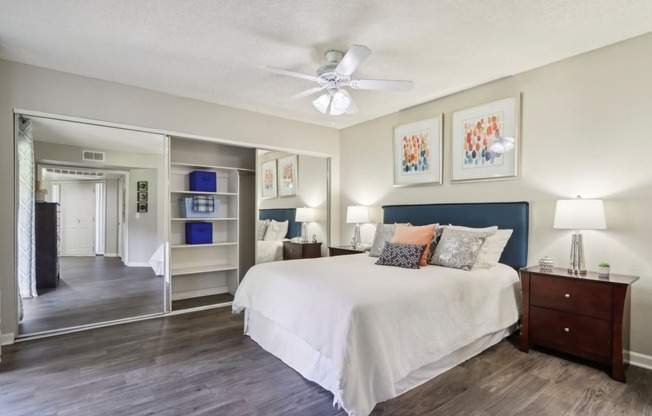 a bedroom with a bed and a ceiling fan